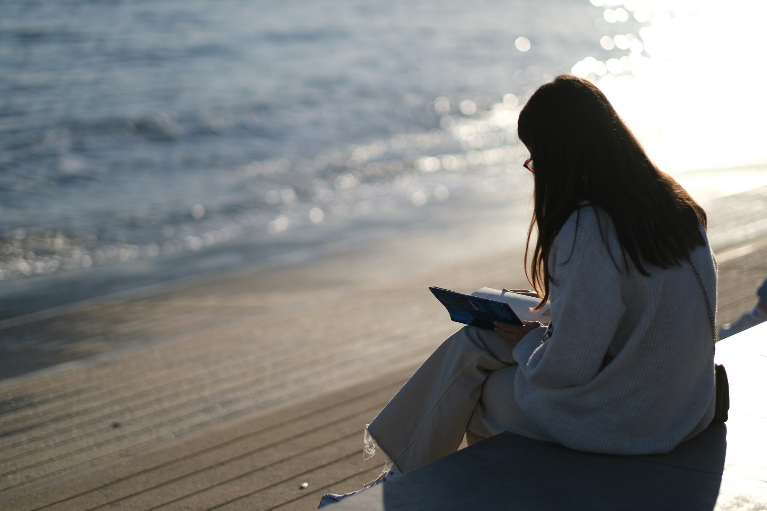 Woman journalling on beach